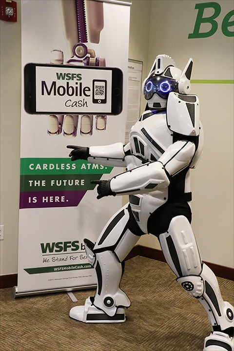 Robot pointing to a banner