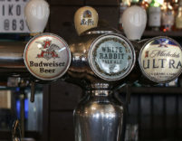 View of several beers taps at a bar.